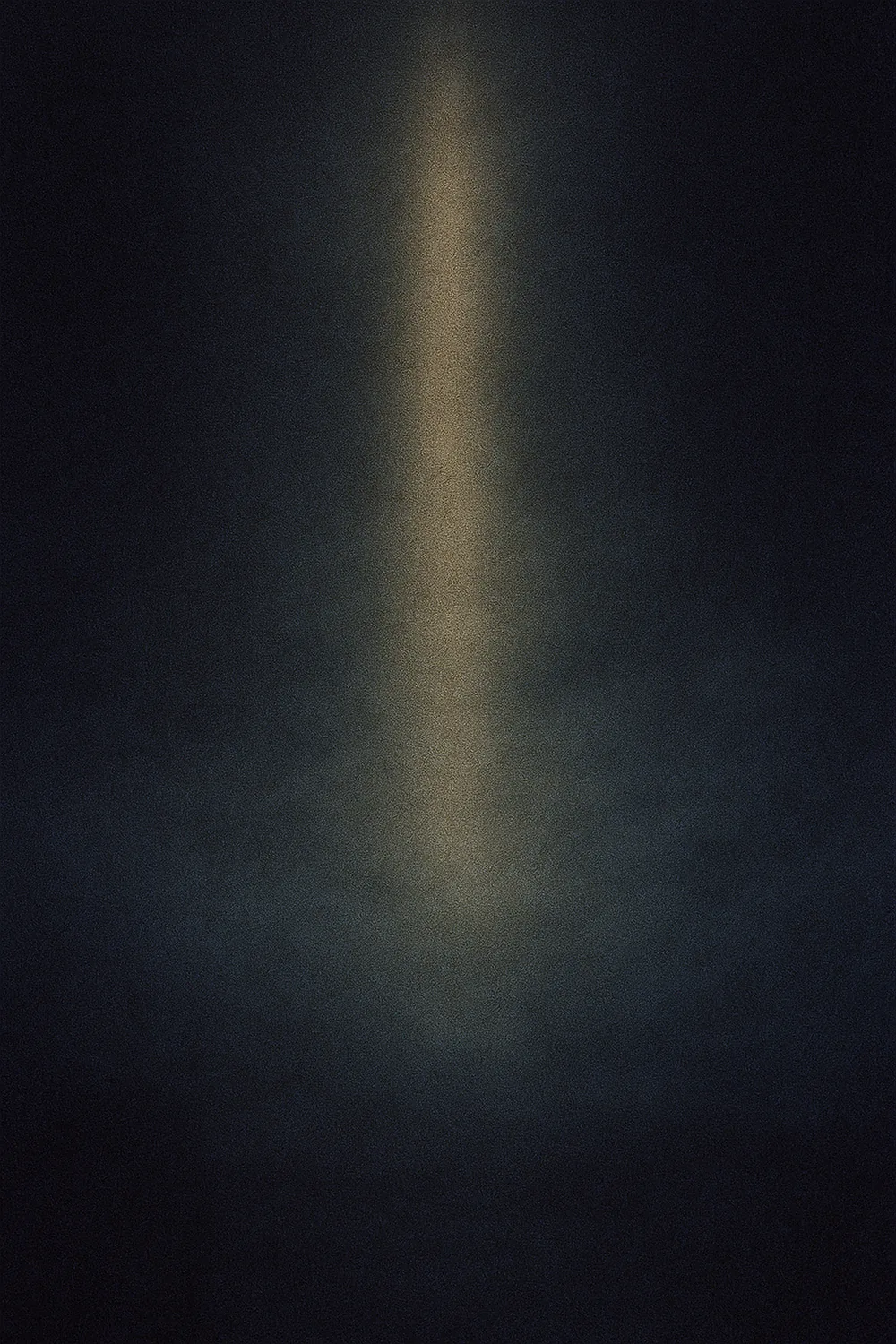 Pale gold shaft of light through near-black indigo